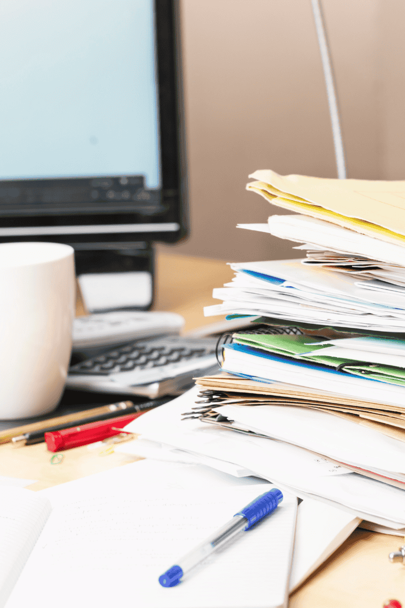 The messy desk of a business owner who can't keep up with marketing